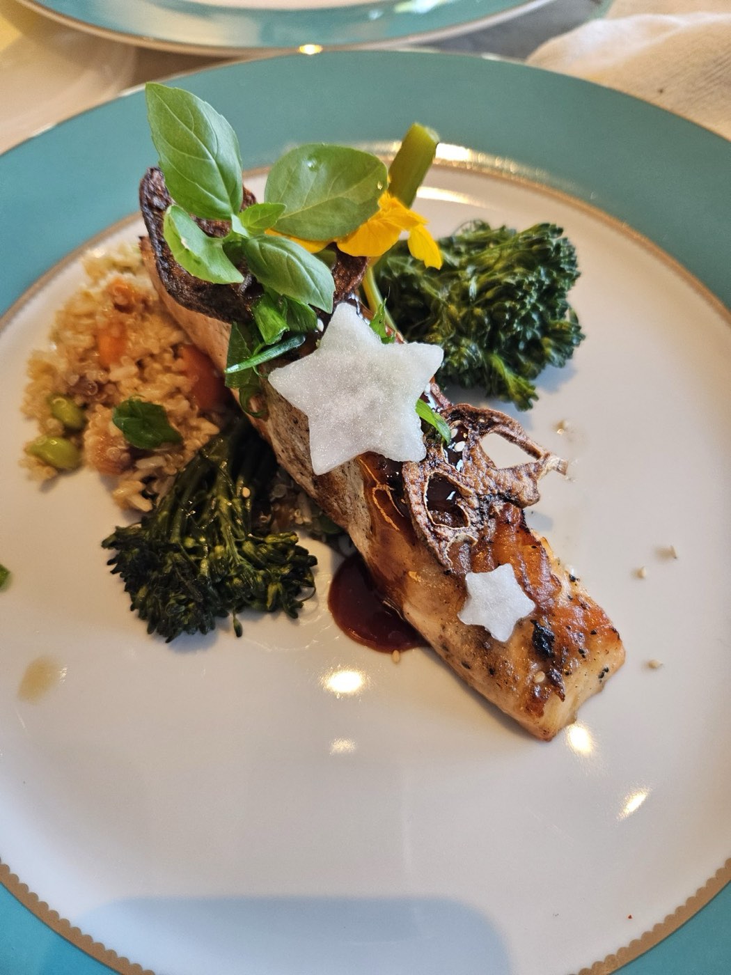 Honey-basil salmon with broccolini and grains on a teal-rimmed plate