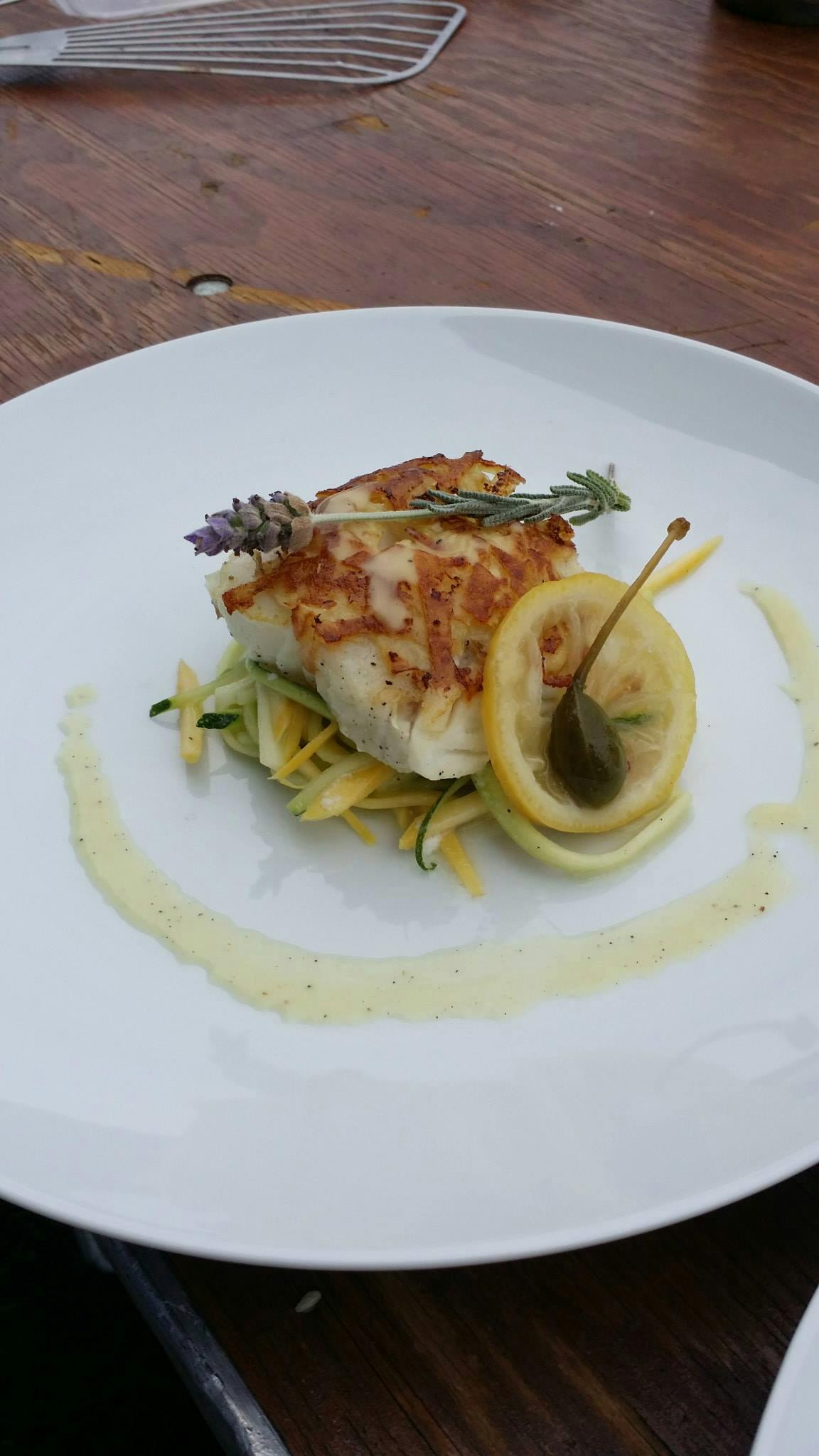 Plated cod with lemon and vegetables